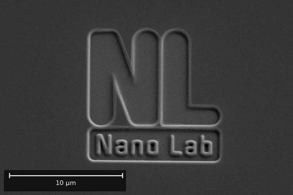 The Nano Lab logo milled into a silicon wafer with a focused ion beam, SEM.